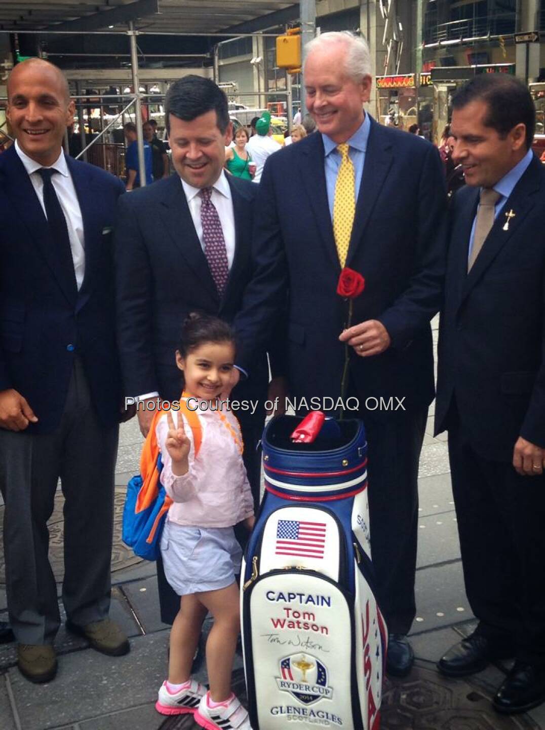 A young fan of the game presents PGA of America leadership with a rose following the #NASDAQ opening bell in Times Square #SheKnowsShesFly #FutureLPGAStar  Source: http://facebook.com/NASDAQ