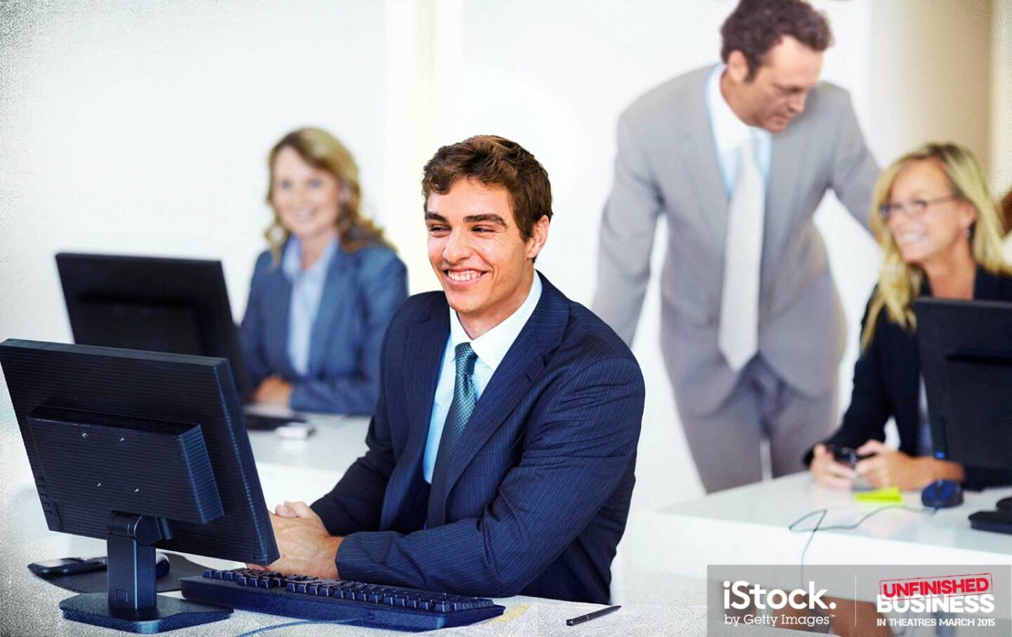 Mike Pancake and Dan Trunkman (Vince Vaughn) are supportive businessmen - Smiling business man sitting at his computer desk, iStock, Getty Images